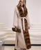 Woman wearing a luxurious beige cashmere coat with rich brown mink fur trim, styled for elegant winter fashion.