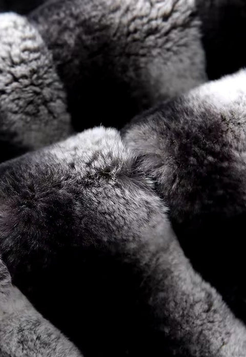 Close-up of the chinchilla-effect Rex Rabbit fur trim on black cashmere, emphasizing the soft gradient tones and velvety texture for a luxurious finish.