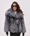 Woman wears a voluminous Silver Fox Fur Coat paired with sleek black leather gloves, showcasing an elegant winter ensemble with full-pelt construction and luxurious texture.